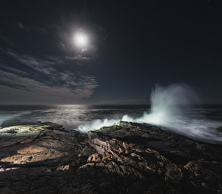 Heavy surf rises towards the Moon on Nova Scotia's Atlantic coast.  Long exposure.