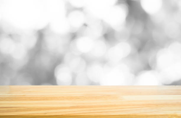 istock Wood table top on white grey bokeh blurred in background 681602690