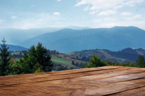 Empty wooden table in the background of the mountains for product montage