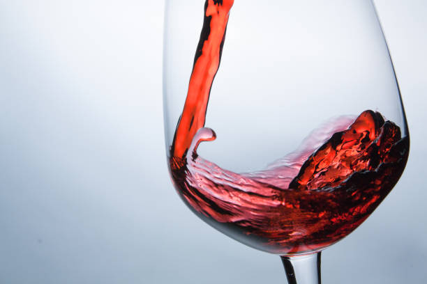 istock wine being pouring into a glass closeup wine splashing splash 681608574