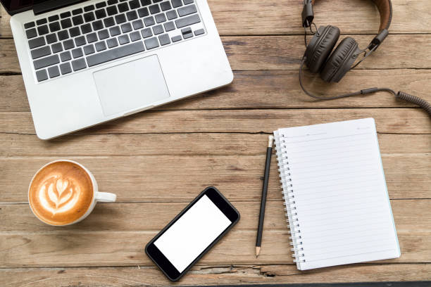 istock office stuff with laptop coffee cup notepad smartphone and headphone 681608958