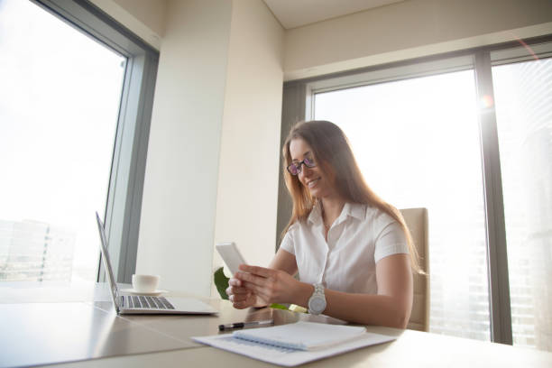 istock Lazy woman playing games on phone at workplace 681615298