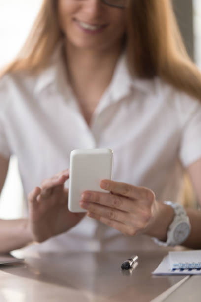 istock Businesswoman reading message on modern cellphone 681615348