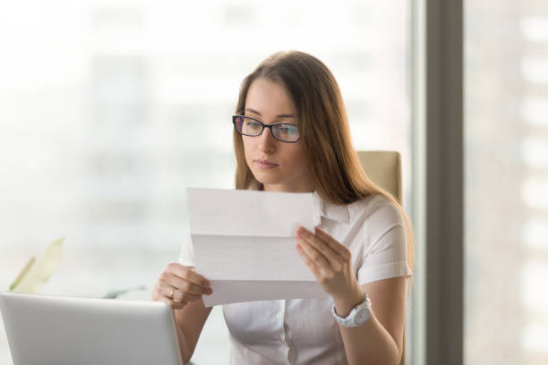 istock Businesswoman reading official document at workplace 681615366