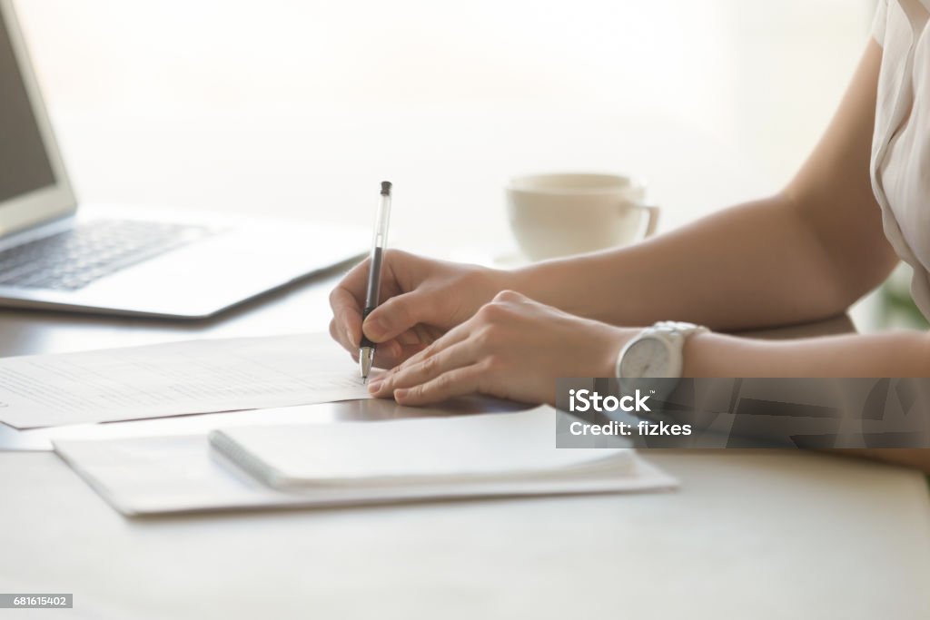 Photo of womans hands with pen signs contract Close up photo of womans hands with pen signs contract. Businesswoman puts her personal signature on business agreement. Female entrepreneur working with business documents. Paperwork in office Document Stock Photo