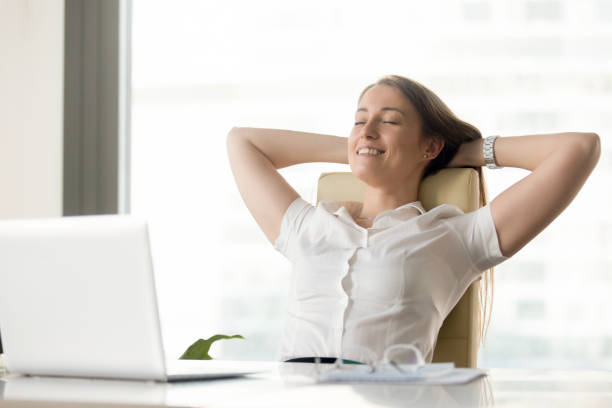 istock Cheerful businesswoman dreaming at workplace 681615432