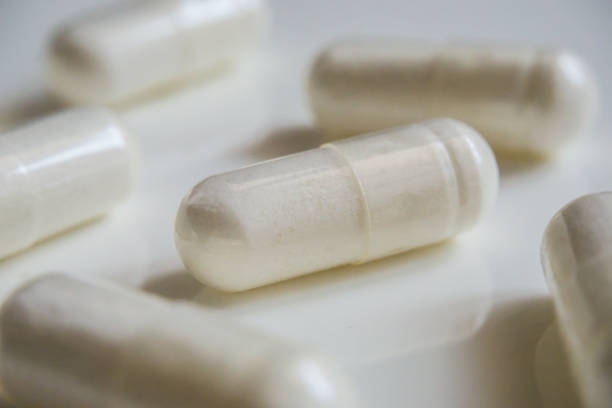 istock Medicine white pills or capsules on white background with copy space. Pharmaceutical medicament for health. 681629236