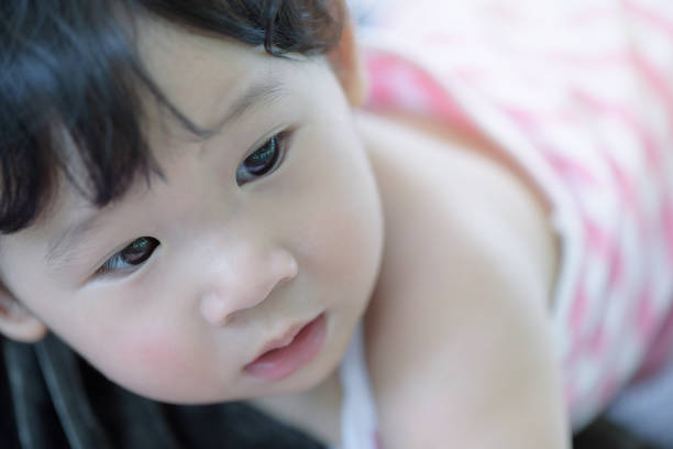 Headshot of cute baby girl in pink. stock photo