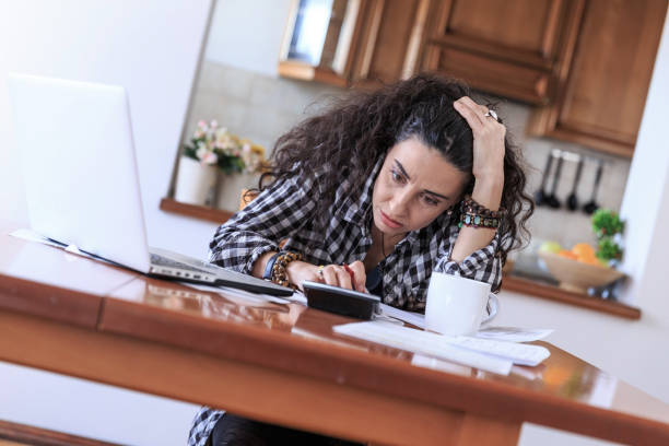 istock Sad woman making home budgeting 681638938