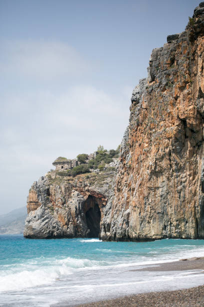 istock Mediterranean beach with turqouise sea and rocks on shore 681639674