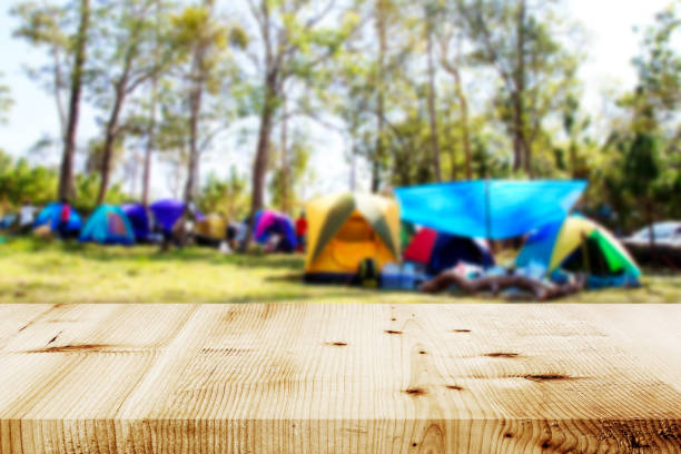 istock Wood table and Blurred camping and tents in forest. 681639796