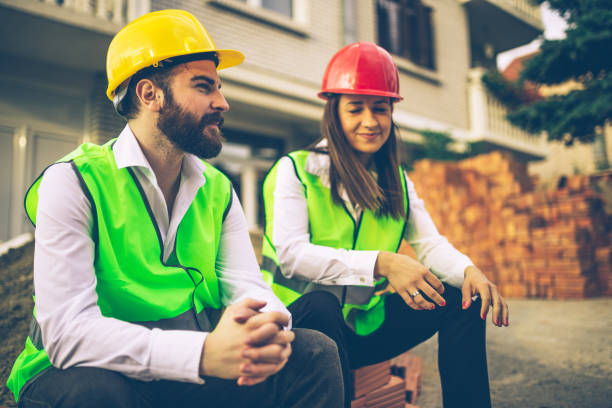 istock Young architects sitting in front of the construction site 681640448