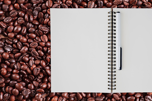 Notebook on coffee beans background