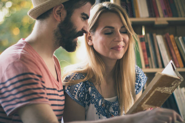 istock Young couple studying in the public libray on a lovely summer day 681642892