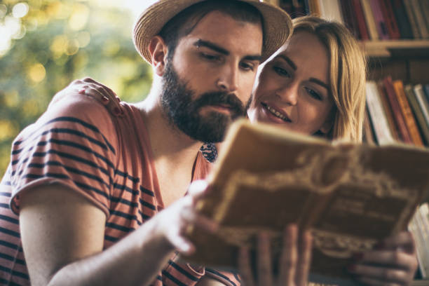 istock Young couple studying in the public libray on a lovely summer day 681643166