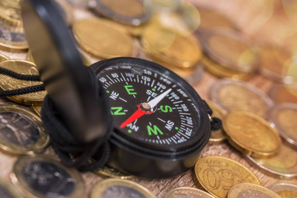 istock Financial concept  - compass with gold coin. close up. 681643542