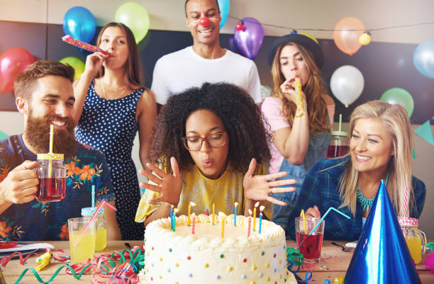 istock Woman blowing out candles on her cake 681643552