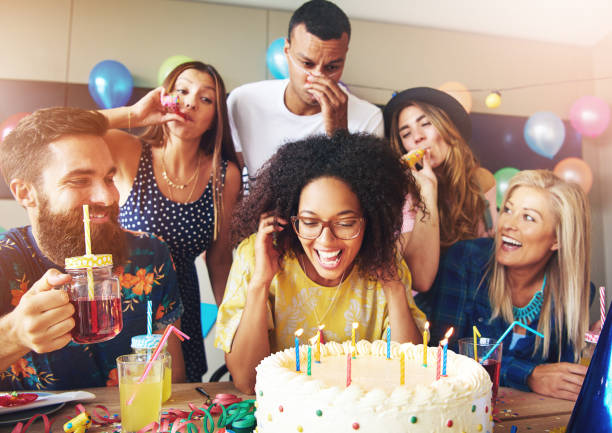 istock Woman blowing candles on cake after making a wish 681643722