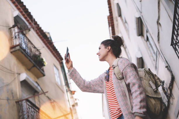 istock young woman using mobile phone on the street 681649594