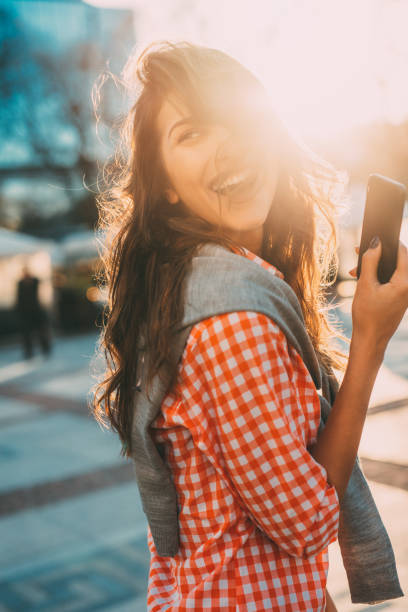 istock Beautiful woman texting outdoors 681650010