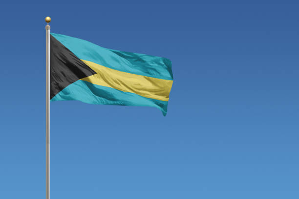 National flag of The Bahamas on a clear blue sky stock photo