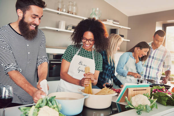 istock Group of friends cheerfully cooking 681655780