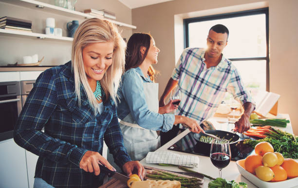 istock Smiling woman slicing ingredients for meal 681657654