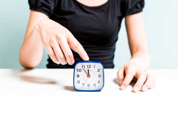 istock Woman and the clock 681659178
