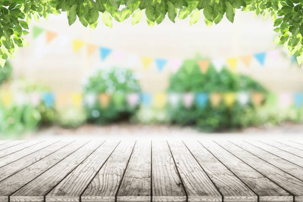 istock Empty wooden table with party in garden background blurred. 681659418