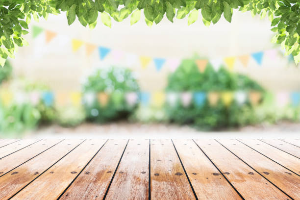 istock Empty wooden table with party in garden background blurred. 681661990