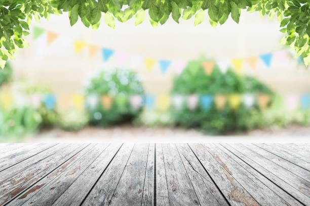 istock Empty wooden table with party in garden background blurred. 681664464