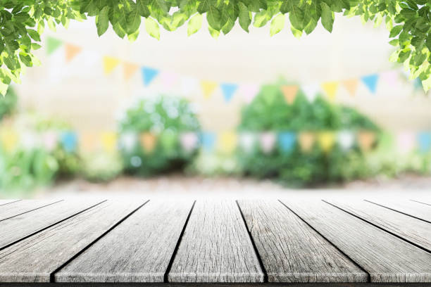 istock Empty wooden table with party in garden background blurred. 681664740