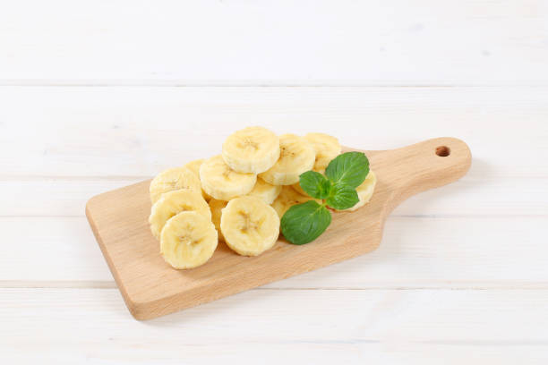 pile of sliced banana on wooden cutting board