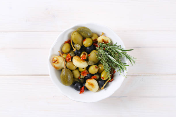 istock pickled olives, capers, caper berries and garlic 681672130