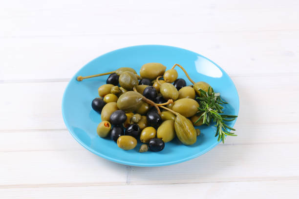istock green and black olives with capers and caper berries 681673862
