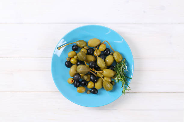 istock green and black olives with capers and caper berries 681677928