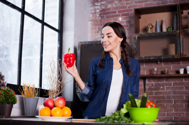istock Young girl keeps the Red Bell pepper in hand 681681488