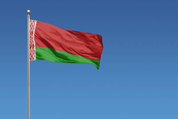 national flag of belarus on a clear blue sky - belarus imagens e fotografias de stock