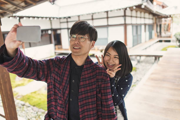 istock Young couple coming to a temple for sightseeing 681722076