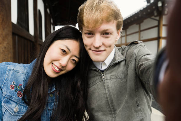 istock Young couple shooting Selphy with a smartphone 681722332