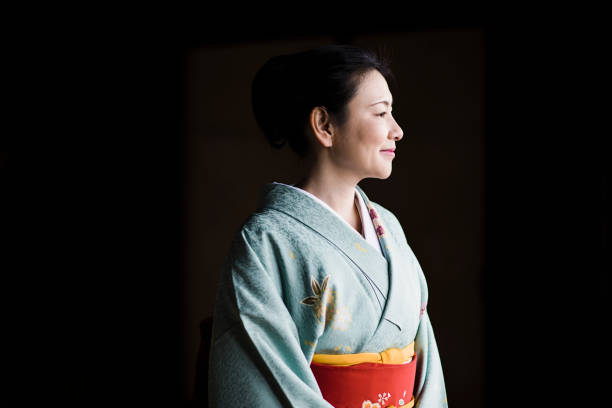 Mature woman in a kimono at a temple Kimono is traditional Japanese clothing kimono stock pictures, royalty-free photos & images