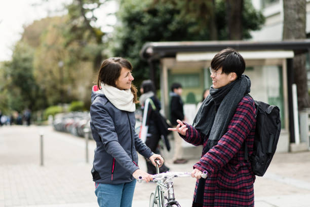istock Friends with a bicycle in city 681723190