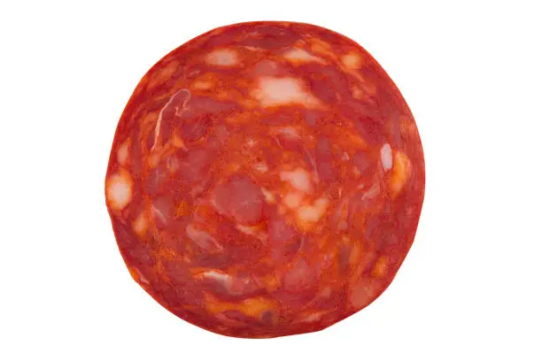 top view macro detail of  pork chorizo salami sausage slice texture isolated on white background