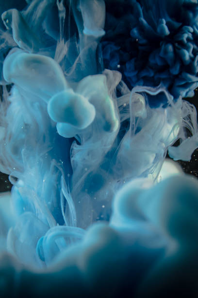 istock blue ink in water isolated on black background 681723862