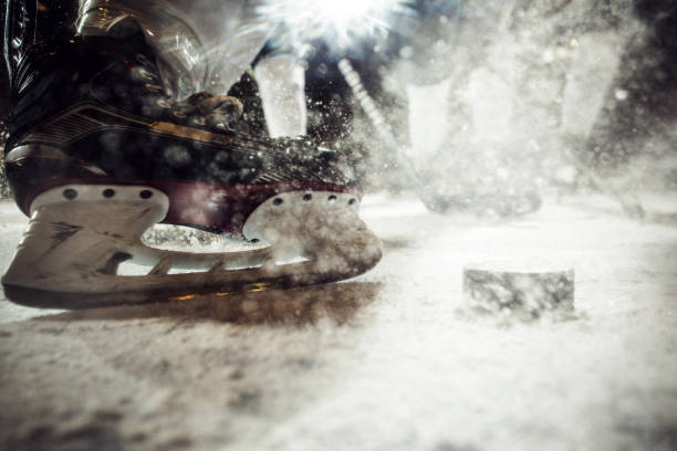 Close up of ice hockey player's skate on ice. Close up of ice skate of unrecognizable ice hockey player during the match. hockey skates stock pictures, royalty-free photos & images