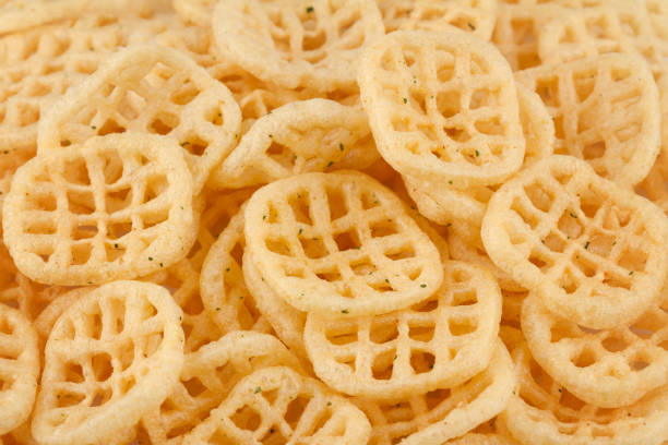 closeup texture background of bacon flavored potato chips on top of each other