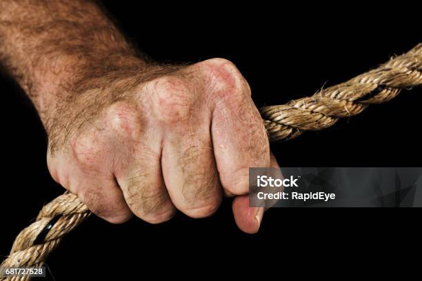 Masculine Hand Grips Rope Holding Fast Black Background Stock Photo - Download Image Now