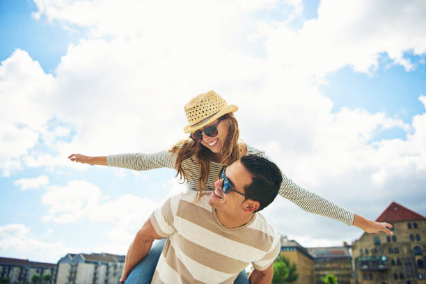 Young couple having fun piggy backing