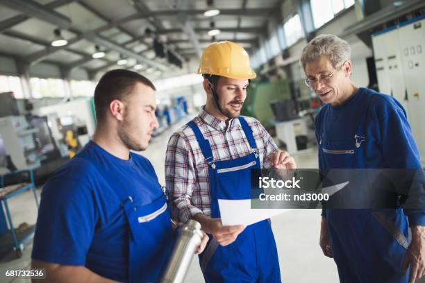 Supplier With Engineer Checking On Production In Factory Stock Photo - Download Image Now