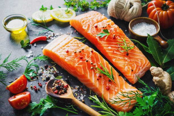 istock Fresh salmon fillet with aromatic herbs, spices and vegetables 681732696
